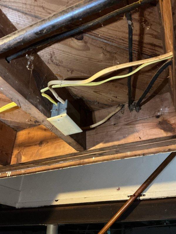 Responded to service call for non-functional electrical outlet with foreign object lodged in receptacle. Upon inspection, found debris obstructing outlet contact points at kitchen counter location. Safely removed lodged material from outlet, verified wiring integrity in accessible attic space above service area, and confirmed proper electrical connections at junction box. Tested outlet functionality post-repair and restored power to receptacle, ensuring safe operation for continued use.