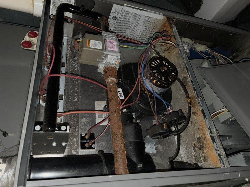 Completed MVP cooling maintenance visit on 8-year-old HVAC system. Removed and replaced severely contaminated air filter that exhibited extensive dirt accumulation, brownish-green organic growth consistent with mold development, and significant structural deterioration with torn edges and fraying. Inspected internal components including gas valve assembly, blower motor, and electrical connections. Noted heavy rust formation on internal metal piping requiring monitoring for future replacement. Observed dust accumulation at unit base and general wear patterns consistent with system age. Verified all electrical connections secure and operational. System returned to service following filter replacement and component inspection.