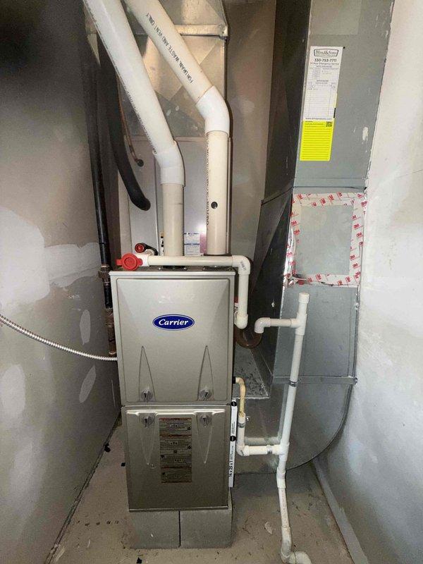 Completed MVP recurring cooling maintenance visit on 14-year-old Carrier HVAC system. Performed comprehensive inspection of indoor unit components including control board, electrical connections, capacitor, and blower motor assembly. Verified proper operation of all system controls and safety devices. Documented equipment condition through photographic records showing accessible components within cabinet and overall installation configuration. All components found operating within normal parameters for unit age.