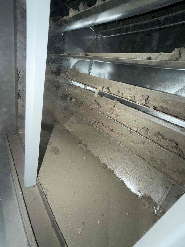 Completed comprehensive duct cleaning service for commercial HVAC system. Removed significant accumulation of dust, debris, and deteriorated material from ductwork and interior compartments. System showed heavy buildup on metal supports, ventilation components, and interior surfaces, indicating extended period without maintenance. All accessible duct sections were thoroughly cleaned and debris extracted from collection points.
