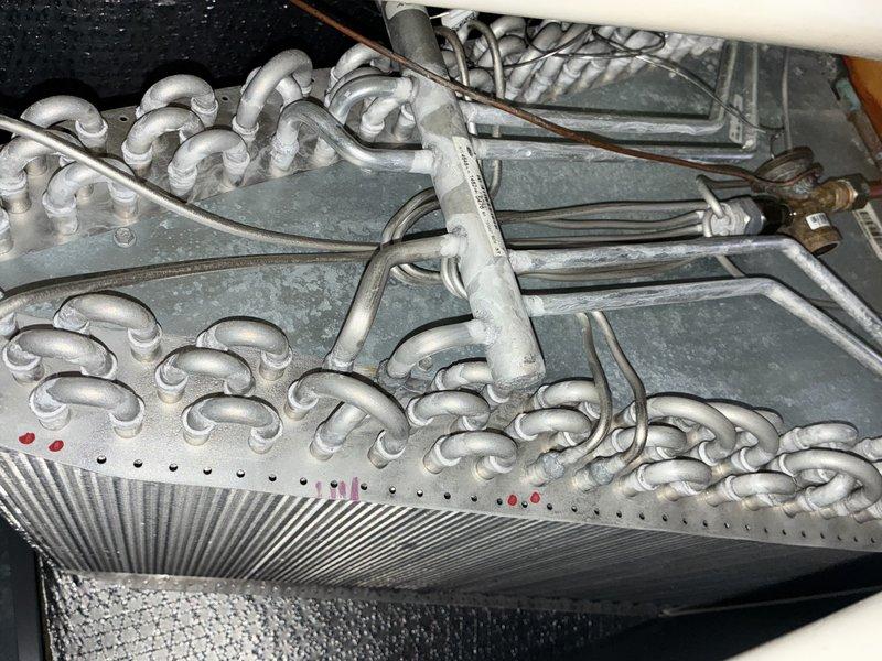 Completed MVP cooling maintenance visit and identified significant evaporator coil icing issue indicating potential refrigerant charge problem, airflow restriction, or system malfunction requiring immediate attention. Inspected air filter which showed moderate dust accumulation and documented system conditions with photos for diagnostic purposes and recommended follow-up repair to address frozen coil condition before resuming normal operation.