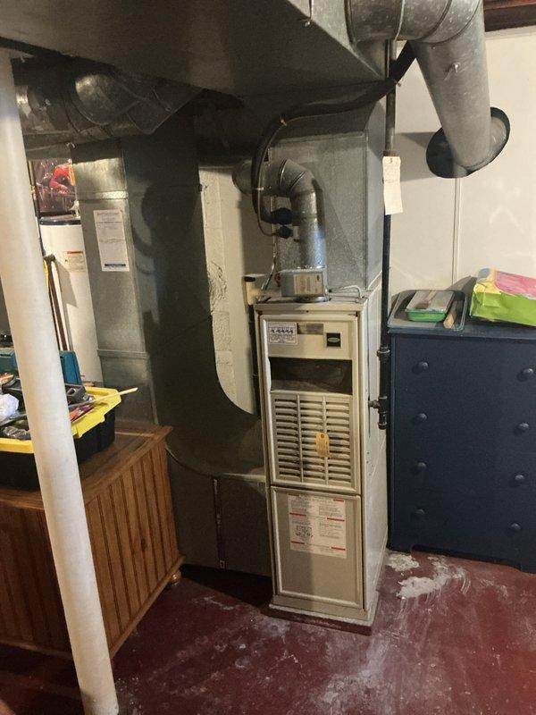 Completed installation of a new 80% efficiency furnace and air conditioning system. The furnace was installed in the basement with new ductwork and plenum connections, while the outdoor condenser unit was positioned against the exterior wall with proper electrical disconnect and conduit routing. Both units were tested and confirmed operational upon completion.