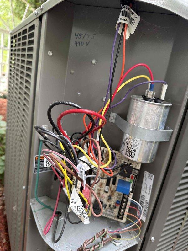 Responded to service call regarding clogged discharge line on 3-year-old outdoor heat pump unit. Upon arrival, performed comprehensive system inspection including removal of access panel to examine electrical components, capacitor (440V 45/9.5 MFD), control board connections, and wiring integrity. Cleared condensate drain line obstruction and verified proper drainage through PVC condensate piping system. Inspected indoor air handler unit and condensate trap assembly, noting moisture accumulation on utility room floor. Completed standard maintenance procedures including checking all electrical connections, verifying proper voltage supply, and ensuring system operational parameters were within manufacturer specifications. Unit tested and returned to normal operation with proper condensate drainage flow restored.