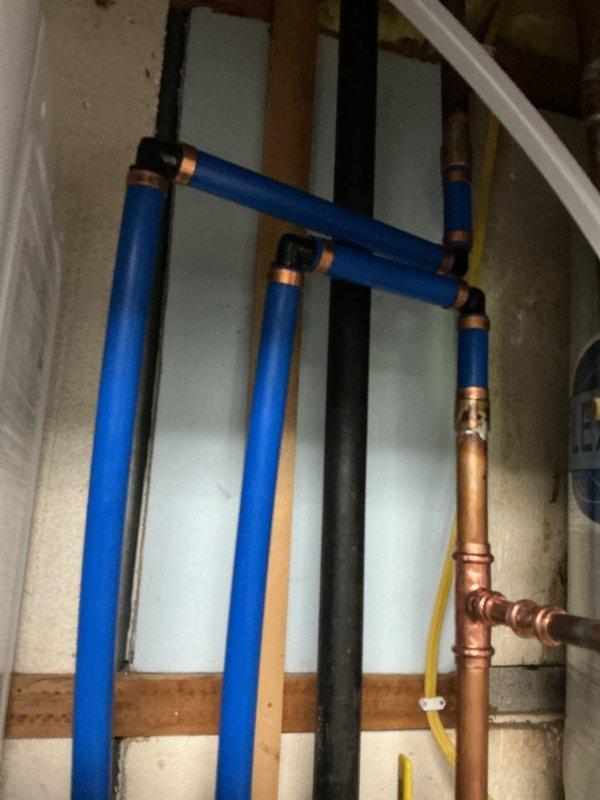 Removed existing water softener system and installed new Water Right sanitizer unit to eliminate well water odors and reduce hardness. Replaced shut-off valve downstream of pressure tank with new ball valve for improved shutoff capability. Removed existing SharkBite fittings at PEX-to-copper transition points and replaced with permanent press-by-crimp fittings to ensure code-compliant, leak-free connections. All plumbing connections tested and verified operational with no leaks detected.