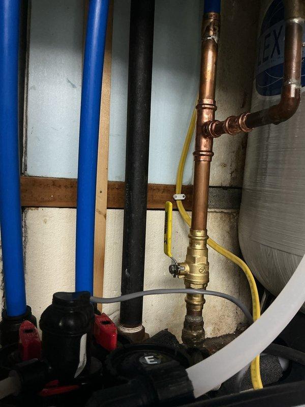 Removed existing water softener system and installed new Water Right sanitizer unit to eliminate well water odors and reduce hardness. Replaced shut-off valve downstream of pressure tank with new ball valve for improved shutoff capability. Removed existing SharkBite fittings at PEX-to-copper transition points and replaced with permanent press-by-crimp fittings to ensure code-compliant, leak-free connections. All plumbing connections tested and verified operational with no leaks detected.