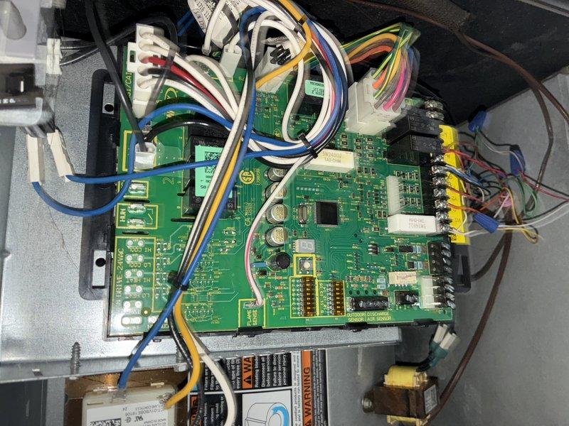Responded to AC service call with customer reporting system issues but uncertain of specific symptoms or equipment age. Upon inspection, accessed control board compartment and heat exchanger assembly to perform diagnostic evaluation. Examined dual PCB control modules, wiring harnesses, relay connections, and terminal blocks for proper operation and secure connections. Inspected heat exchanger coils and refrigerant lines for condition and integrity. System components photographed for service records. Unit operational at time of departure.