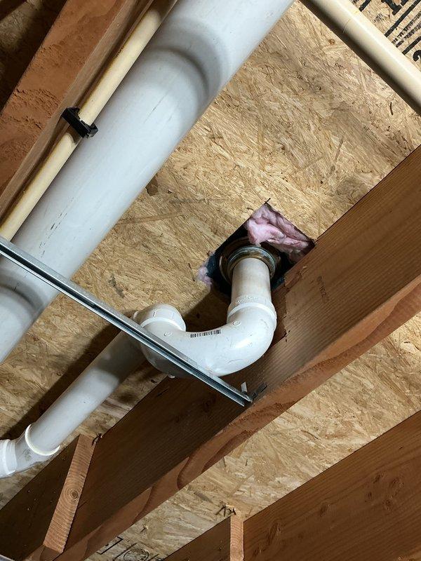 Responded to service call for leaking shower drain. Accessed plumbing beneath shower unit through crawl space, identified failed drain assembly seal causing water intrusion. Removed and replaced drain gasket and compression fitting on PVC drain line. Tested system for proper drainage and verified leak repair was successful with no further water seepage detected.