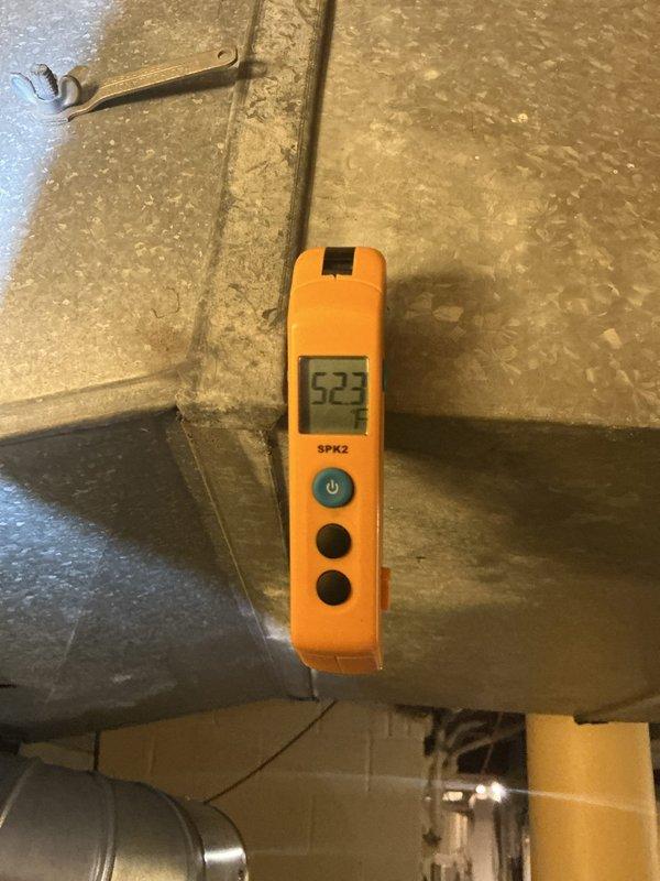 # HVAC Service - No Cool Diagnostic

Responded to no cooling complaint on residential HVAC system less than 10 years old. Performed diagnostic assessment of system operation and measured supply air temperature at ductwork, recording reading of 52°F. Conducted visual inspection of exterior components including condensing unit location and surrounding areas. Identified debris accumulation at roofline and gutter system near outdoor unit that could potentially restrict airflow or impact system performance. Documented system conditions with diagnostic measurements and photographic evidence for service records.