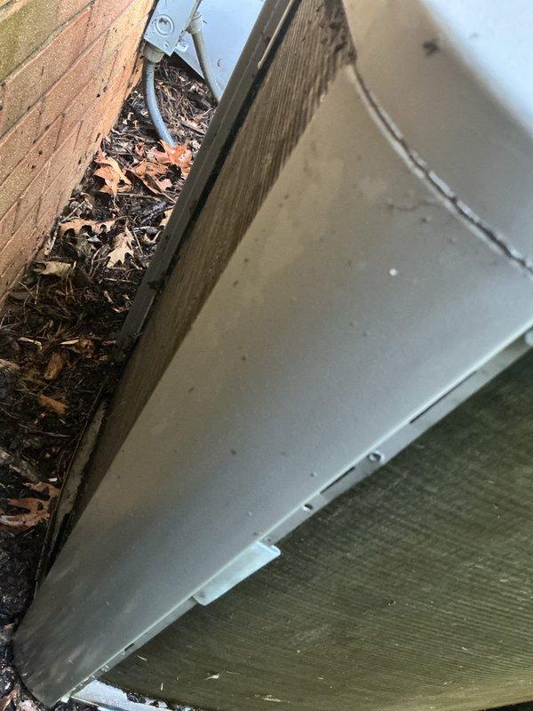 # HVAC Service - No Cool Diagnostic

Responded to no cooling complaint on residential HVAC system less than 10 years old. Performed diagnostic assessment of system operation and measured supply air temperature at ductwork, recording reading of 52°F. Conducted visual inspection of exterior components including condensing unit location and surrounding areas. Identified debris accumulation at roofline and gutter system near outdoor unit that could potentially restrict airflow or impact system performance. Documented system conditions with diagnostic measurements and photographic evidence for service records.