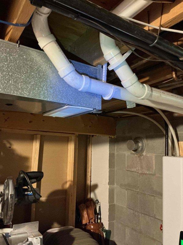 Completed on-site electrical estimate for standby generator installation in unfinished basement utility area. Assessed existing electrical infrastructure including main service panel, conduit routing pathways, and available space for generator transfer switch installation. Documented current electrical configuration with multiple branch circuits, PVC and metal conduit runs along ceiling joists, and concrete block foundation walls suitable for equipment mounting. Photographed utility room layout showing HVAC ductwork, plumbing systems, and electrical panel to determine optimal placement for automatic transfer switch and feeder conductors from future generator location.