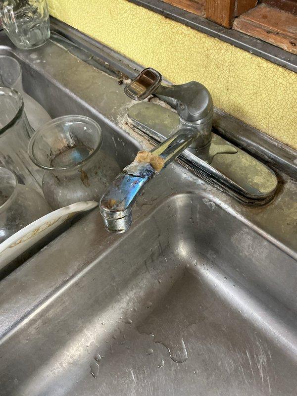Responded to service call for outdoor spigot leaking at basement connection point. Upon diagnostic inspection, identified corroded galvanized supply pipe feeding exterior hose bib that was causing water leakage when spigot was activated. Documented existing plumbing conditions including deteriorated piping, mineral buildup, and signs of previous moisture damage in cabinet area beneath sink. Provided assessment and quote for repair of leaking outdoor spigot supply line and discussed separate estimate for installation of customer-supplied faucet fixture. Customer also inquired about yard drainage issues occurring during heavy rainfall requiring future evaluation.