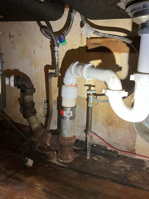 Responded to service call for outdoor spigot leaking at basement connection point. Upon diagnostic inspection, identified corroded galvanized supply pipe feeding exterior hose bib that was causing water leakage when spigot was activated. Documented existing plumbing conditions including deteriorated piping, mineral buildup, and signs of previous moisture damage in cabinet area beneath sink. Provided assessment and quote for repair of leaking outdoor spigot supply line and discussed separate estimate for installation of customer-supplied faucet fixture. Customer also inquired about yard drainage issues occurring during heavy rainfall requiring future evaluation.