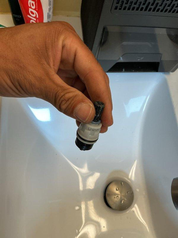 Responded to a leaking bathroom sink faucet equipped with a widespread three-piece fixture in brushed nickel finish. Diagnosed the issue as a failed valve cartridge in one of the handles, removed the defective cartridge, and installed a replacement component. Tested the faucet operation and verified no leaks were present upon completion.