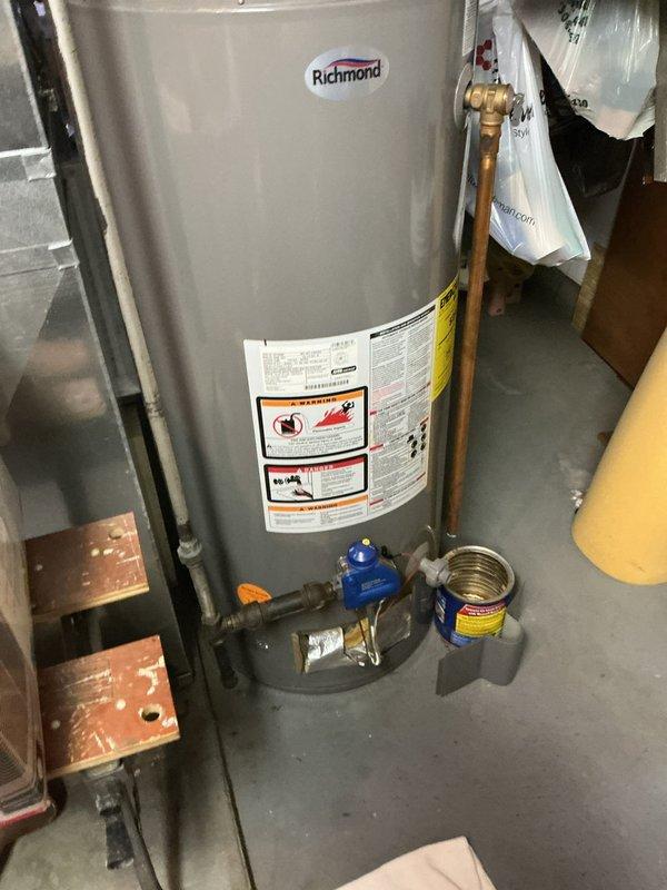 Responded to service call for non-operational water heater. Upon arrival, inspected Richmond-branded 40-gallon natural gas water heater (Model BC49S-34F3, 34,000 BTU input) manufactured in May 2015. Documented unit specifications including serial number U211625339, maximum working pressure rating of 150 PSI, and AHRI certification. Performed visual assessment of unit condition, plumbing connections including copper piping and brass fittings, blue valve mechanism at base, and overall installation setup in basement utility area. Photographed water heater labels, warning decals, and technical specification plates for service records. Provided free estimate for necessary repairs or replacement options to restore hot water functionality.