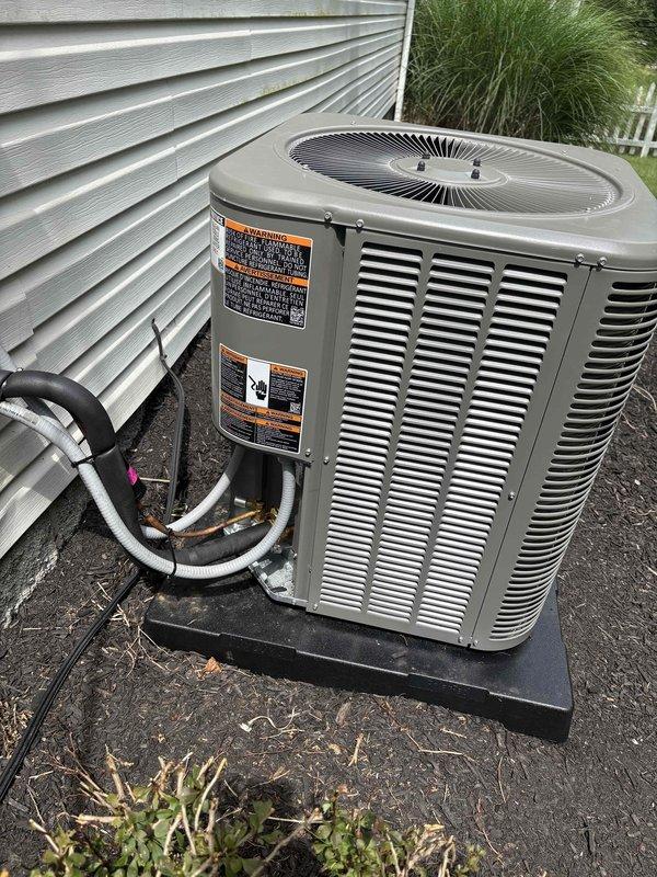 Conducted warranty inspection on recently installed outdoor condensing unit and identified missing tamper-proof caps on refrigerant service valves. Documented deficiency with photographs showing yellow standard caps instead of required tamper-proof caps on both liquid and suction line service ports. Job placed on hold pending manager approval for corrective action to meet code compliance requirements.