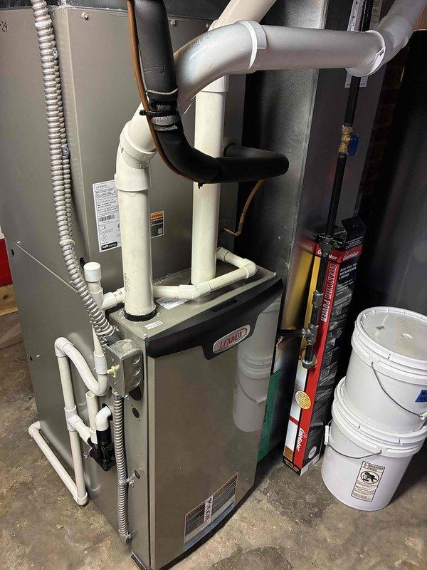 Completed preventive maintenance cooling visit on residential HVAC system. Inspected outdoor condensing unit and indoor Lennox furnace with cooling coil, cleaned condenser coils of accumulated debris and dust, verified refrigerant lines and condensate drainage system operation, and confirmed all components functioning properly. System tested and left in good working order for continued cooling season operation.
