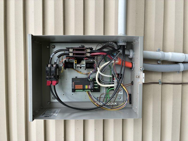 Responded to service call for generator system experiencing transfer switch malfunction and requiring routine maintenance. Upon arrival, performed comprehensive diagnostic evaluation of the automatic transfer switch (ATS) panel and generator unit. Opened and inspected the electrical transfer panel, examining all internal components including circuit breakers, control module with LED display, power distribution terminals, and associated wiring connections.

Identified faulty transfer switch control board causing improper operation between utility and generator power sources. Tested voltage levels, verified proper grounding, and inspected all wire terminations for secure connections. Checked generator engine oil level and determined oil change was due based on operating hours and service intervals. Performed complete oil and filter change on generator unit, accessing internal components through service panels. Inspected blower motor assembly and cooling system components for proper opera