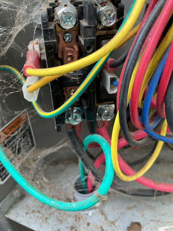 Completed MVP AC maintenance on Lennox HVAC system in basement utility room. Performed comprehensive cooling system inspection, including examination of furnace unit, electrical connections, and associated components. Inspected terminal block connections with multiple colored wires, noting dust accumulation and environmental exposure typical of basement installations. Verified proper operation of white PVC exhaust and intake vent pipes extending from furnace top. System operational and ready for cooling season.