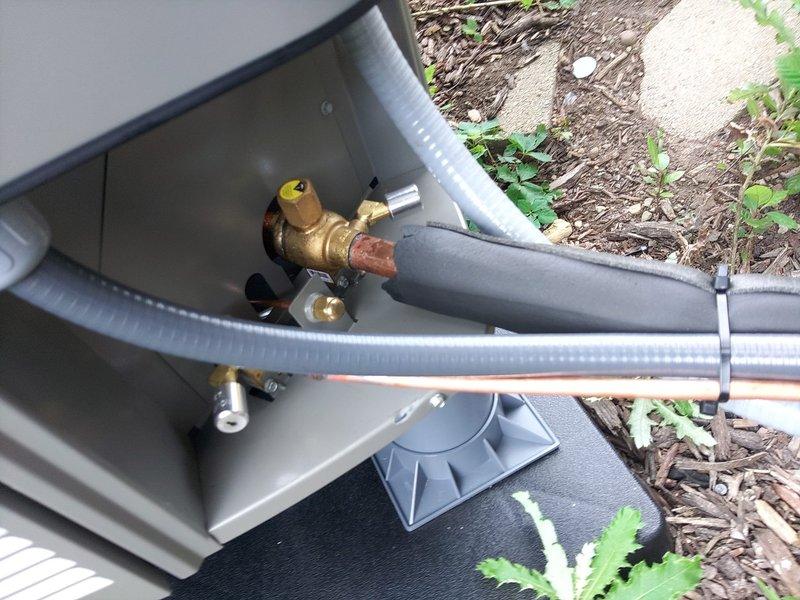 Completed full system replacement under warranty at residential property. Accessed property using provided garage code, removed existing HVAC equipment and installed new system. Verified proper refrigerant charge of R410A using digital manifold gauges, with system pressures reading 121.6 psi on low side and 292.2 psi on high side at operating temperatures of 41°F evaporator and 94°F condenser. Inspected outdoor unit installation including lineset connections, service valves, and electrical conduit routing. Confirmed all copper piping properly insulated and secured on protective pad with appropriate clearances. Documented system performance with photos showing gauge readings and exterior equipment installation. Transported old equipment back to shop for disposal. System operating within manufacturer specifications upon completion.