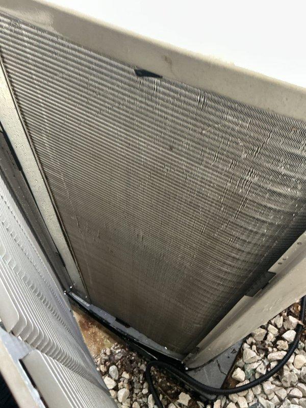Completed MVP recurring cooling maintenance visit on residential HVAC system. Inspected outdoor condenser unit, noting significant debris accumulation on protective mesh screen and general weathering of exterior surfaces. Accessed indoor air handler unit and examined evaporator coil assembly, which showed clean condition with clearly visible mesh pattern and properly positioned refrigerant lines across the coil surface. Verified blower assembly and internal components were functioning properly with no immediate concerns noted.