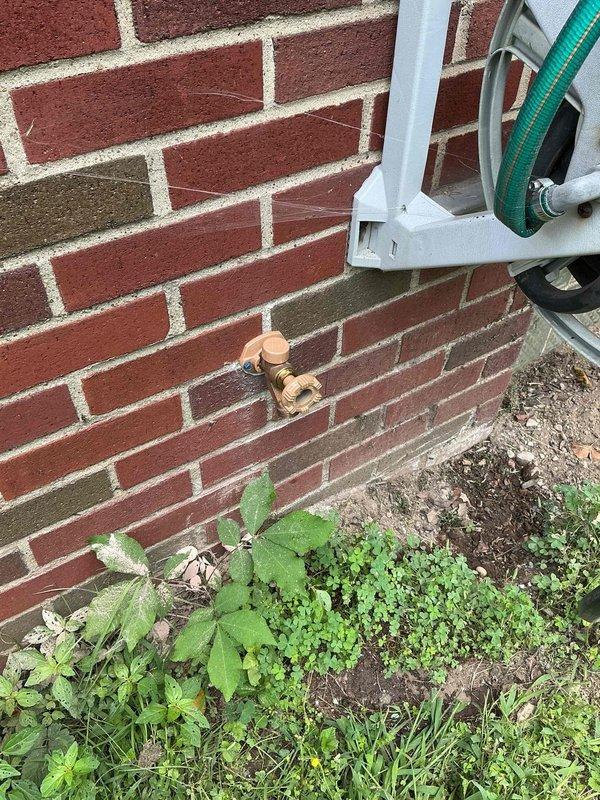 Diagnosed and repaired non-functional exterior hose bib mounted on brick wall. Accessed interior plumbing connections in basement crawl space area, where supply lines run through floor joists above insulated foundation walls. Restored proper water flow to outdoor spigot, resolving issue with failed valve mechanism.