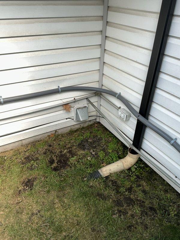 Conducted site assessment for additional electrical work at residential property. Evaluated existing exterior electrical installation including conduit routing, junction box placement, and weatherproofing requirements along building perimeter. Inspected narrow access area adjacent to sliding glass door to determine feasibility for new electrical runs and identified debris accumulation and maintenance access constraints. Documented current conditions of exterior-mounted conduit system and junction boxes for preparation of detailed electrical estimate. Photographed existing installations to support scope development for proposed additional electrical work.