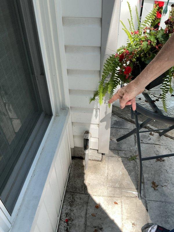 Conducted site assessment for additional electrical work at residential property. Evaluated existing exterior electrical installation including conduit routing, junction box placement, and weatherproofing requirements along building perimeter. Inspected narrow access area adjacent to sliding glass door to determine feasibility for new electrical runs and identified debris accumulation and maintenance access constraints. Documented current conditions of exterior-mounted conduit system and junction boxes for preparation of detailed electrical estimate. Photographed existing installations to support scope development for proposed additional electrical work.