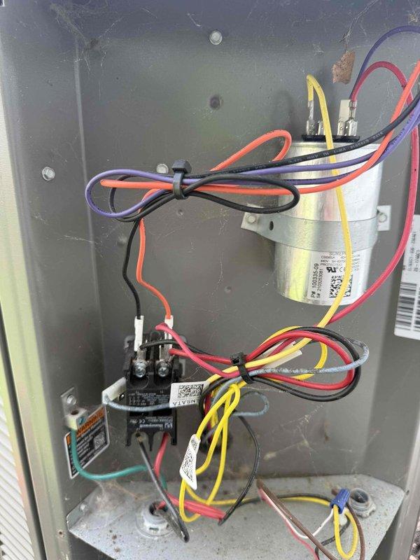 Completed comprehensive maintenance visit on 22-year-old air conditioning system under MVP maintenance agreement. Performed thorough inspection of outdoor condensing unit and indoor air handler components, including examination of evaporator coil assembly with louvered curved ductwork connections. Inspected electrical control panel, verifying proper operation of dual-run capacitor, contactor relay, and all associated wiring connections. All electrical terminations were secure with proper color-coded wiring intact. System operational and functioning within normal parameters at time of service completion.