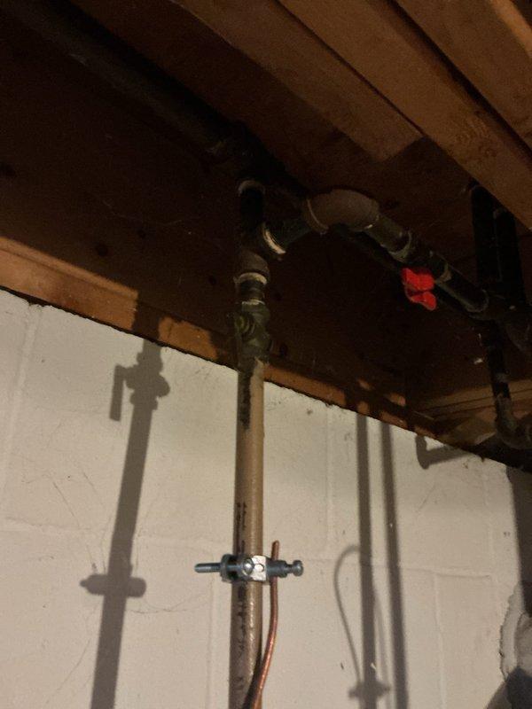 Responded to service call for leaking water heater. Upon arrival, conducted comprehensive inspection of tanked water heater system and surrounding plumbing infrastructure. Identified active water leak originating from water heater unit, evidenced by visible water staining and discoloration on concrete floor beneath equipment. Examined all water heater connections, including copper supply lines, shutoff valves, and discharge piping. Assessed condition of existing water heater, noting age, capacity, and overall operational status. Documented current plumbing configuration including vertical copper piping with brass fittings, PVC discharge line, and isolation valves. Photographed leak source, water damage extent, and existing equipment setup for estimate preparation. Provided customer with detailed assessment of repair versus replacement options based on severity of leak and equipment condition. Prepared free estimate for water heater replacement including removal of existing unit, instal