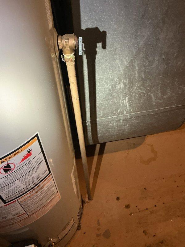 Responded to service call for leaking water heater. Upon arrival, conducted comprehensive inspection of tanked water heater system and surrounding plumbing infrastructure. Identified active water leak originating from water heater unit, evidenced by visible water staining and discoloration on concrete floor beneath equipment. Examined all water heater connections, including copper supply lines, shutoff valves, and discharge piping. Assessed condition of existing water heater, noting age, capacity, and overall operational status. Documented current plumbing configuration including vertical copper piping with brass fittings, PVC discharge line, and isolation valves. Photographed leak source, water damage extent, and existing equipment setup for estimate preparation. Provided customer with detailed assessment of repair versus replacement options based on severity of leak and equipment condition. Prepared free estimate for water heater replacement including removal of existing unit, instal