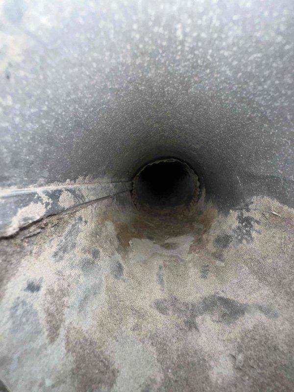 Completed dryer vent cleaning service with heavy lint accumulation removed from the exhaust opening and ductwork. The vent showed significant buildup of fibrous material and debris that was restricting airflow, which was thoroughly cleaned to restore proper ventilation and reduce fire hazard risk.