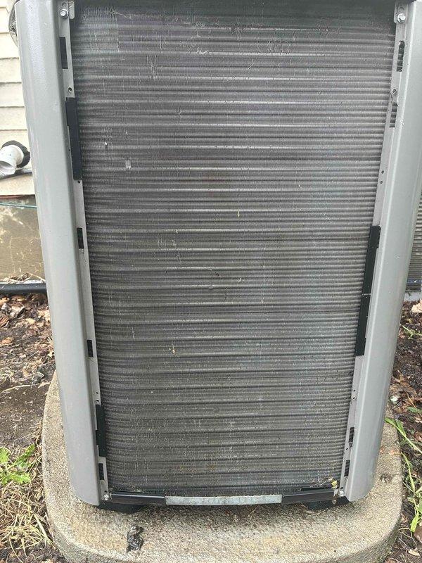 Completed comprehensive AC tune-up on Blind and Sons outdoor condensing unit of unknown age with no reported operational issues. Performed standard maintenance protocol including system inspection, which revealed moderate dirt and debris accumulation on condenser coil fins and evaporator coil assembly with visible dust buildup and discoloration on heat transfer surfaces. Documented equipment condition through photographic evidence showing fin surface contamination and outdoor unit requiring cleaning attention for optimal heat exchange efficiency.