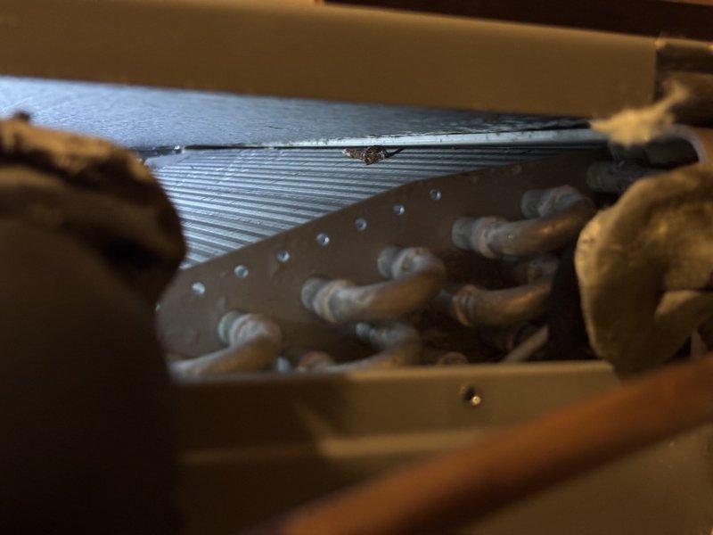 Completed scheduled maintenance on 7-year-old air conditioning system. Inspection revealed significant corrosion on drainage components, which were documented and addressed. Performed standard maintenance procedures including examination of evaporator coil assembly, refrigerant line connections, and condensate system integrity to ensure proper cooling system operation.