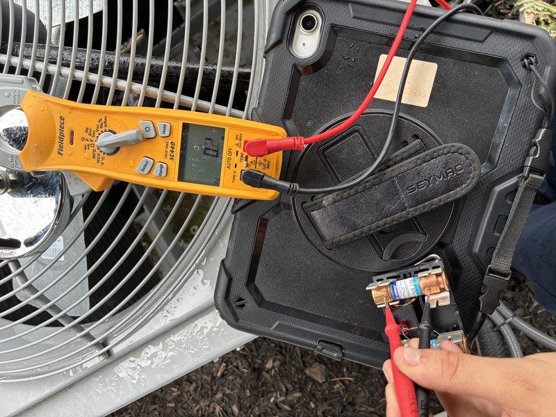 # HVAC Service - A/C

Responded to no-cooling call for 3-year-old outdoor condensing unit that failed to start. Performed electrical diagnostics using digital multimeter to test voltage and continuity at the contactor and dual run capacitor. Testing revealed failed capacitor with 0.0 reading, preventing compressor and condenser fan motor from starting. Replaced defective dual run capacitor, verified proper voltage supply to unit, and confirmed system startup with compressor and fan motor operating normally.