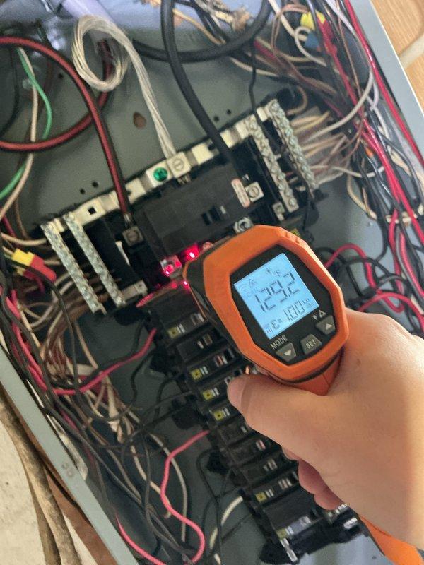 Responded to service call for recurring breaker trips and reported burning smell. Performed diagnostic testing of electrical panel using digital multimeter, confirming voltage readings at 124.2V and inspecting all circuit breaker connections and wiring terminations. Identified disorganized wiring conditions within panel and inspected basement utility area electrical connections serving washing machine and associated appliances to isolate the source of the electrical fault and eliminate the safety hazard.