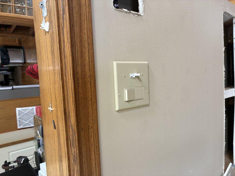 Relocated double light switch approximately one foot from original position per customer request. Installed new electrical box at desired location, cut drywall access openings as needed, and completed wiring connections. Patched and finished wall opening, installed new switch plate cover, and verified proper operation of both switches.