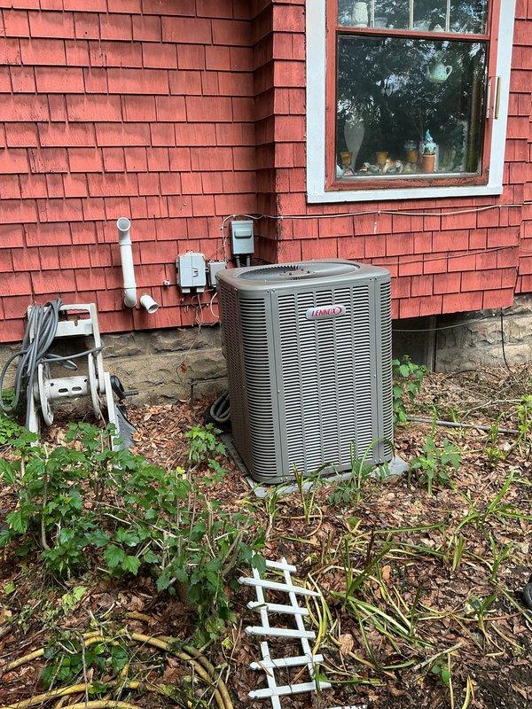 # HVAC Maintenance - Cooling

Completed comprehensive MVP cooling maintenance visit on residential Lennox air conditioning system. Performed thorough inspection of outdoor condenser unit and indoor evaporator coil assembly. Indoor coil exhibited significant accumulation of dirt and dust throughout aluminum fin array, restricting airflow and reducing heat exchange efficiency. Opened access panels on evaporator unit to assess coil condition and document maintenance needs through photographic documentation.

Inspected outdoor condenser unit positioned on ground-level pad adjacent to structure. Unit surrounded by vegetation, mulch, and debris requiring clearance maintenance. Verified proper clearance around condenser housing and assessed fin condition on exterior heat exchanger. Documented equipment location, surrounding conditions, and accessibility for ongoing maintenance requirements.

System operational at time of inspection. Maintenance visit completed per MVP recurring service agreem