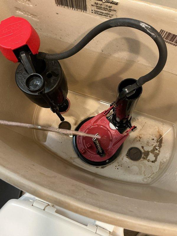 Responded to service call for multiple plumbing issues including garage faucet leak, malfunctioning toilet, and water heater concerns servicing the master bathroom. Inspected toilet tank and identified deteriorated internal components with significant mineral buildup and sediment accumulation on flush valve and fill valve assembly; flapper showed wear and discoloration from hard water deposits. Assessed water heater condition and examined associated plumbing connections and supply lines. Documented all findings with photographs for customer records and provided recommendations for necessary repairs including toilet tank component replacement to restore proper flushing operation.