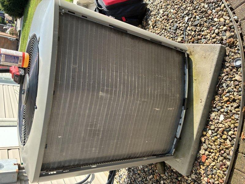 Completed MVP recurring cooling maintenance visit on 2-year-old system. Inspected outdoor condensing unit, noting dirt and debris accumulation on condenser coil surfaces; cleaned coil fins to restore proper airflow and heat transfer efficiency. Examined air filtration system and verified filter condition and proper installation in frame. Unit operational with no mechanical issues identified during inspection.