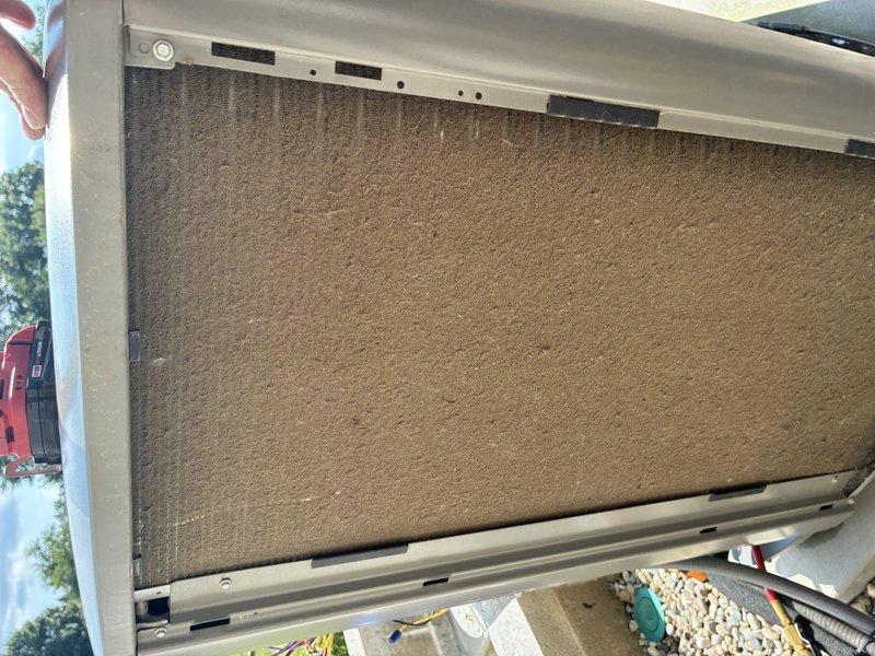 Completed MVP recurring cooling maintenance visit on 2-year-old system. Inspected outdoor condensing unit, noting dirt and debris accumulation on condenser coil surfaces; cleaned coil fins to restore proper airflow and heat transfer efficiency. Examined air filtration system and verified filter condition and proper installation in frame. Unit operational with no mechanical issues identified during inspection.