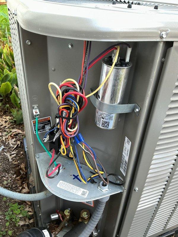 Completed MVP cooling maintenance visit on residential HVAC system. Performed standard system inspection including crawl space ductwork evaluation where temperature readings of 68.4°F were recorded using calibrated digital instrumentation. Verified proper insulation integrity on supply ductwork with reflective barrier material intact and properly secured. Inspected outdoor condensing unit with panel removal to access internal components. Verified electrical connections on all wire terminals including power and control wiring. Inspected capacitor mounting and security, confirmed proper installation and labeling. Evaluated control board connections and wiring organization. Checked refrigerant line insulation and copper tubing routing for proper installation. All components found operating within normal parameters with no immediate service needs identified. System documented photographically for maintenance records.