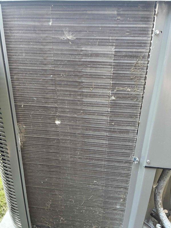 Completed comprehensive AC tune-up on 5-year-old system including inspection of condenser coil and blower assembly. Condenser coil showed moderate dirt accumulation and environmental deposits on fins; blower wheel exhibited dust buildup requiring attention for optimal airflow and efficiency. All components inspected and system confirmed operational.