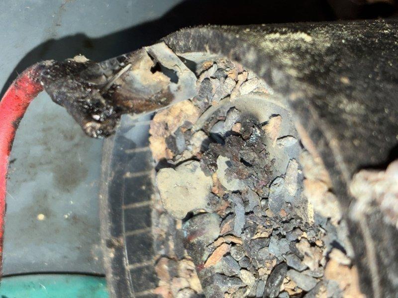 Completed scheduled MVP cooling maintenance visit. Upon inspection, discovered severe corrosion and electrical deterioration on motor capacitor and associated wiring connections. The capacitor exhibited extensive surface corrosion with flaky, grayish buildup indicating electrical failure. Connection points showed heavy oxidation and burned residue, presenting potential safety hazard and immediate failure risk. Component and surrounding area displayed significant dust accumulation and environmental degradation. Documented conditions with photographic evidence for service records. Recommended immediate replacement of affected capacitor and electrical connections to restore safe operation and prevent system failure.
