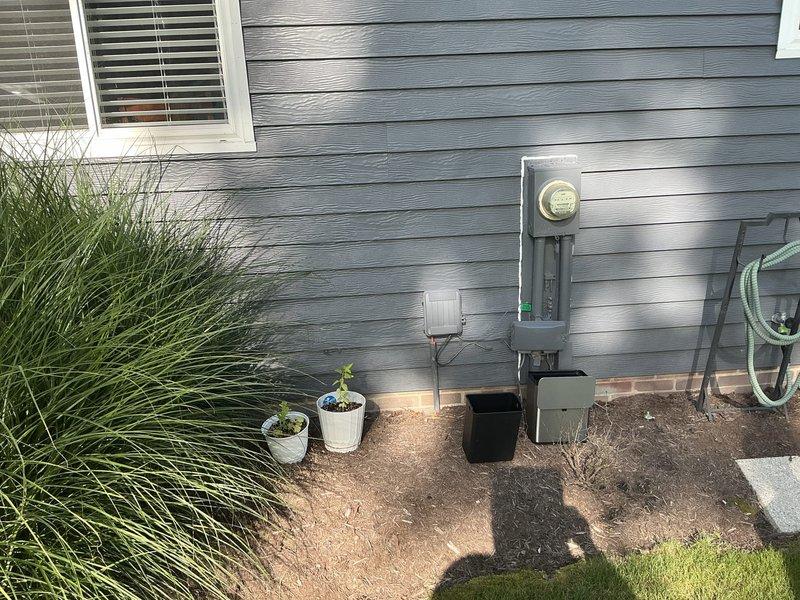 Conducted on-site evaluation for whole-house generator installation at a 1979-built residential property with no existing backup power system. Assessed current electrical service entrance, metering equipment, and available utility connections including an existing propane tank located on the side of the structure. Documented existing electrical infrastructure, service panel accessibility, and potential generator placement locations to provide comprehensive installation quote.