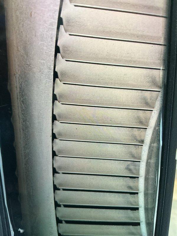 Completed MVP air conditioning maintenance service at 8am as confirmed. Performed system inspection and documented thermostat operation showing 20-degree display reading on White-Rodgers unit. Observed evaporator coil with moderate dust and debris accumulation on fins, indicating need for routine cleaning to maintain optimal airflow and system efficiency.
