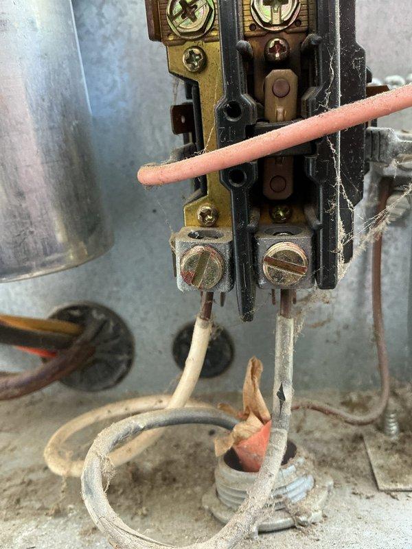 Responded to service call for non-functioning air conditioning system on 23-year-old outdoor condensing unit. Upon inspection, diagnosed failed run capacitor at the contactor assembly. Replaced defective capacitor with new component, verified all electrical connections at terminal block were secure, and tested system operation. Unit returned to normal cooling function with proper amp draw and compressor operation.