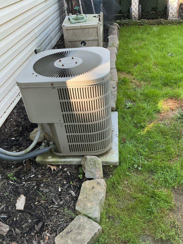 Responded to service call for non-functioning air conditioning system on 23-year-old outdoor condensing unit. Upon inspection, diagnosed failed run capacitor at the contactor assembly. Replaced defective capacitor with new component, verified all electrical connections at terminal block were secure, and tested system operation. Unit returned to normal cooling function with proper amp draw and compressor operation.