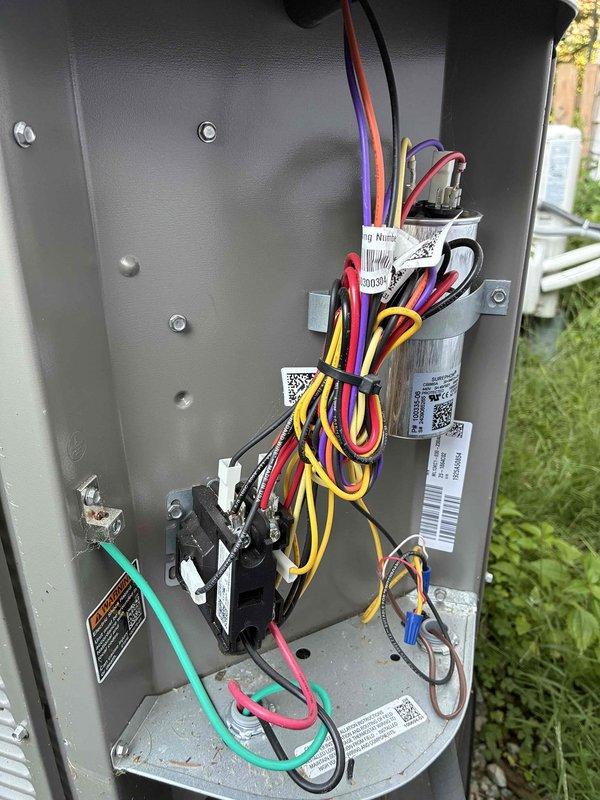 Completed MVP cooling maintenance visit on residential HVAC system. Performed comprehensive inspection of indoor air handler unit and outdoor condensing unit, documenting equipment condition through photos. Inspected electrical control panel, capacitor, and all associated wiring connections for proper operation. Noted copper refrigerant line showing surface oxidation and corrosion on vertical run near air handler cabinet. All electrical components, including digital controller with green indicator lights, operating within normal parameters. System tested and confirmed operational at completion of maintenance visit.