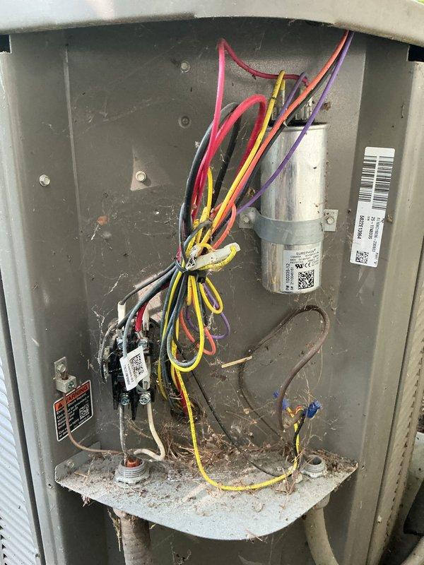 Completed comprehensive air conditioning tune-up service including inspection of electrical control panel, wiring connections, and capacitor. Observed dust accumulation on ventilation components and interior surfaces; all electrical connections verified secure and system operational.