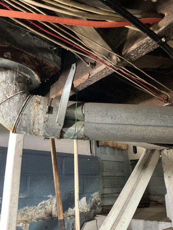 Responded to service call for 9-year-old furnace with reported slamming damper noise in ductwork system. Upon inspection of the HVAC infrastructure, examined the flexible metallic ductwork, main supply ducts, and air handler connections throughout the basement area. Investigated potential sources of noise including loose duct strapping, unsecured flexible duct sections, and vibration points where ductwork interfaces with the furnace unit. Documented existing conditions of the galvanized metal ductwork and air distribution system for customer records.